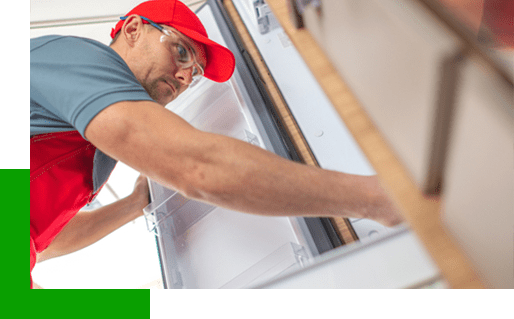 man repairing an RV fridge
