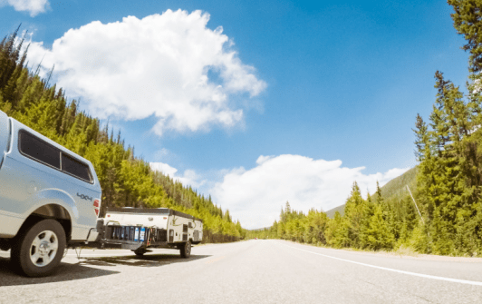 Truck Towing the Compressed Pop up Camping Trailer